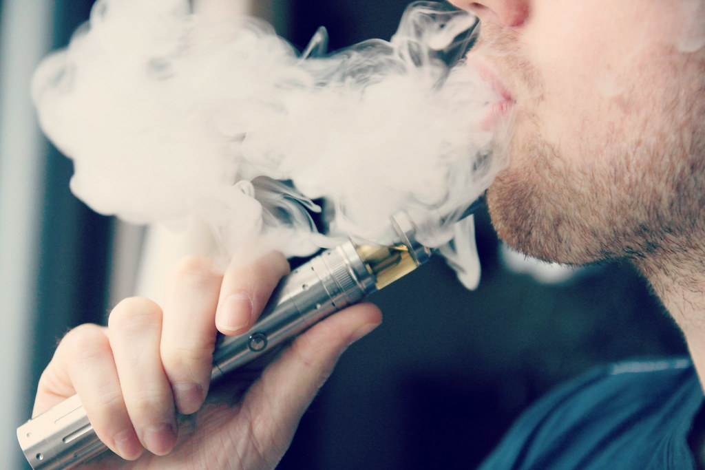 Man exhaling vapor from an e-cigarette