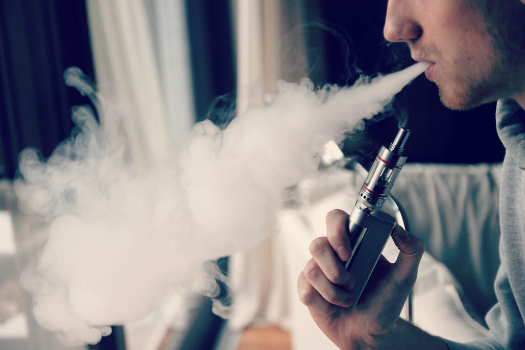 Man exhaling vapor from an e-cigarette
